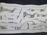 an open book with a drawing of various tools on it