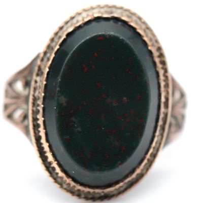 an image of a ring with a green stone