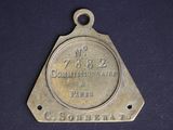 an old brass plate with the name of a town on it