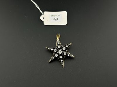 a gold and diamond star pendant with a price tag