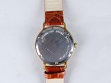 a close up of a wrist watch on a white surface