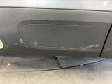 a car that has been dented and is in the garage