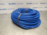 a blue hose on a table in front of a wall