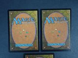 two decks of magic the gathering are shown on a blue surface