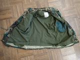 a camouflage jacket laying on the floor on the floor