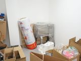 a room with many boxes and other items on the floor