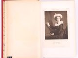 an open book with a black and white photo of a woman in a dress