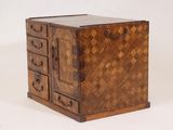 a small wooden box with drawers on top of it