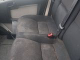 a seat in the back of a car that is dirty
