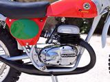 a red and green dirt bike parked on the street