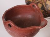 many different types of pottery on display on a table