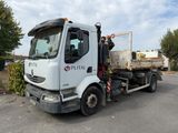un camion blanc garé sur le parking