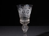 a wine glass with a pattern on it on a table