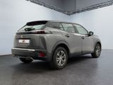 the rear end of a silver suv parked in a garage