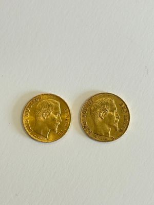 two gold coins with a woman ' s face and a man ' s head