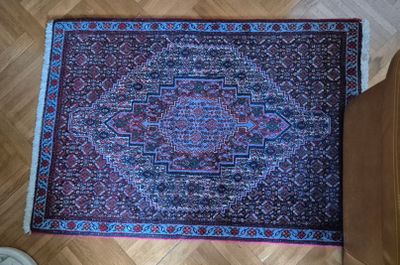 an oriental rug on the floor next to a pair of shoes