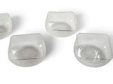four square glass dishes with a white background