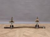 pair of antique brass and marble architectural bookends on a parqueted wood floor