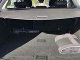 the back of a car with its trunk open and a blanket in the trunk