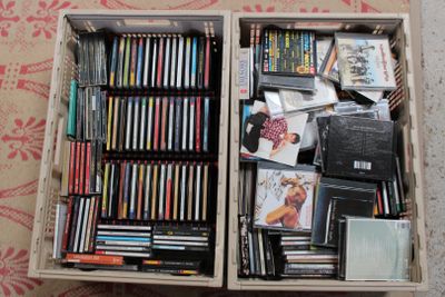 a box full of dvds and cds on the floor