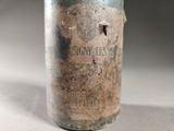 a glass bottle that has some dirt inside of it