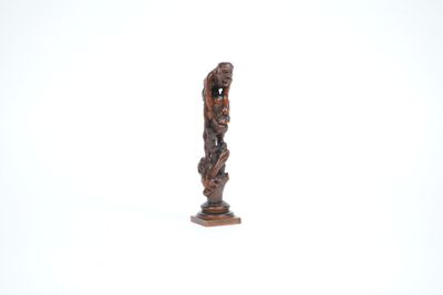 a small statue of a man with a bird on his head