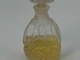 a small glass bottle with a yellow substance inside of it