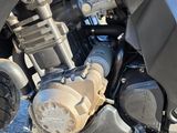 a close up view of a motorcycle engine on the ground