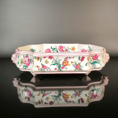 a white bowl with pink and yellow flowers on it
