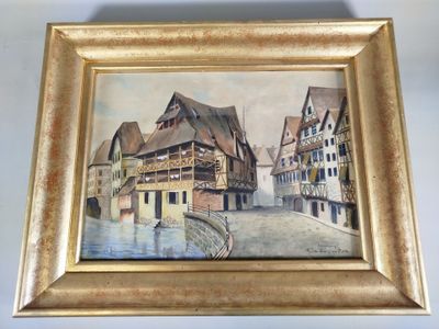 une photo d'un tableau représentant une ville, dans un cadre doré