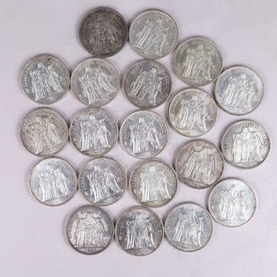 de nombreuses pièces d'argent sur une surface blanche