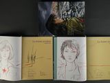 three books on a shelf with drawings of people