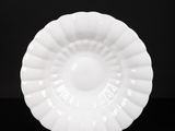 a white plate sitting on top of a black table