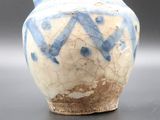 a blue and white vase sitting on a table
