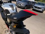 a motorcycle parked on the side of the road next to some cars