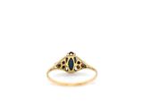a close up of a gold ring with a blue stone