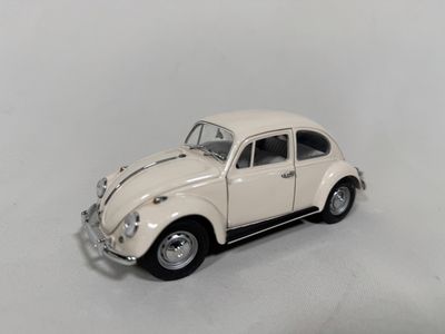 a small toy car that is sitting on a white surface