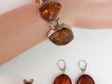 bracelet and earring set with amber stones on a mannequin hand