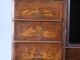 a wooden chest of drawers with birds and flowers painted on it