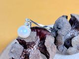 a ring with a pearl sitting on top of a rock