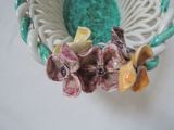 a small bowl with flowers on it sitting on a table