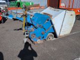 a blue machine that is sitting in a parking lot