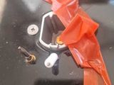 an orange bag with ear buds and a pair of ear buds