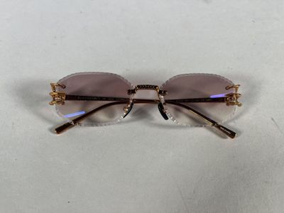 a close up of a pair of glasses on a white surface