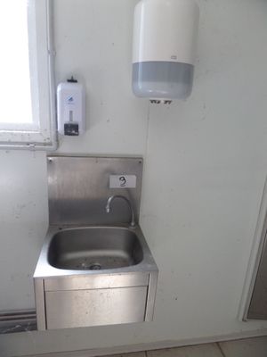 a sink in the corner of a small bathroom