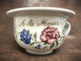 a white bowl with flowers painted on it on a table
