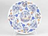 a blue and white plate with blue and orange designs on it