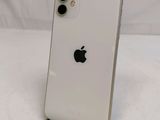 an apple iphone is sitting on a stand on a white surface