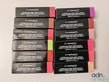 mac cosmetics lipsticks are lined up on a white surface