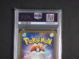 a close up of a pokemon card on a black surface